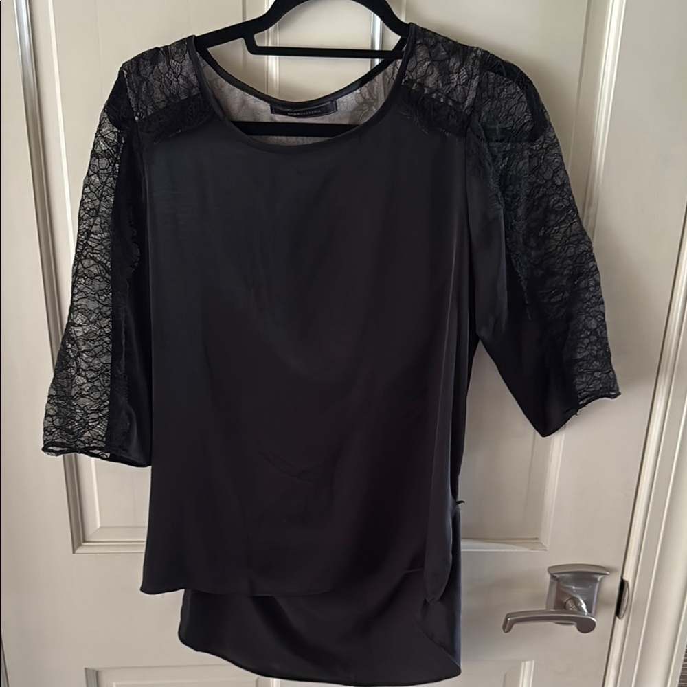 BCBGMaxAzria Black Asymmetrical laced trim top draped back.